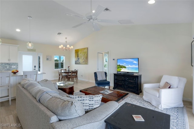 living room featuring light wood-type flooring, ceiling fan with notable chandelier, and lofted ceiling