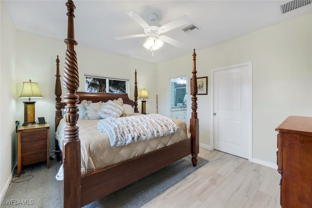 bedroom with ceiling fan, connected bathroom, and light hardwood / wood-style flooring