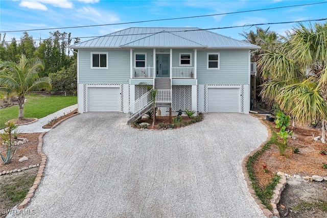 coastal home with a garage and a porch