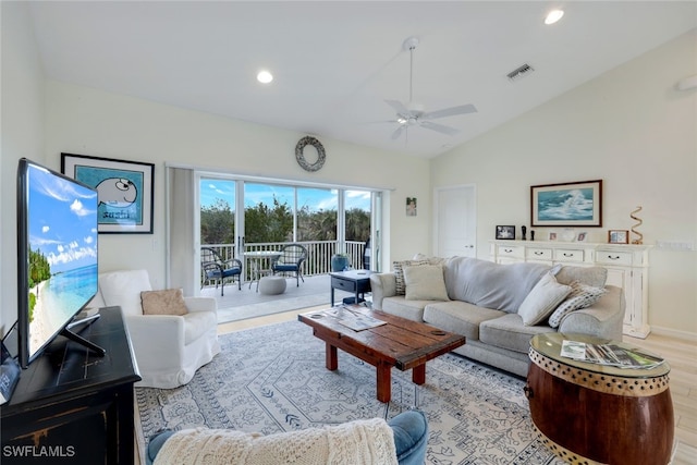 living room featuring ceiling fan, light hardwood / wood-style floors, and lofted ceiling