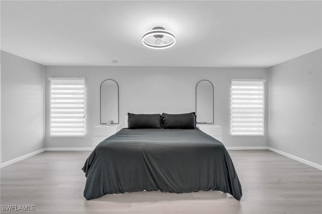 bedroom featuring light hardwood / wood-style floors and multiple windows