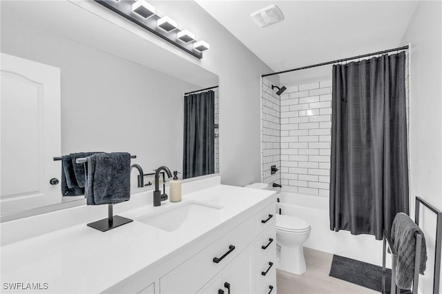 full bathroom featuring shower / bath combo, vanity, and toilet