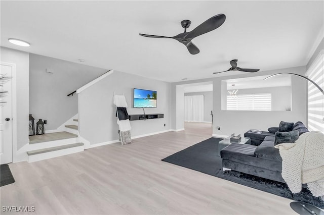 living room featuring light hardwood / wood-style floors and ceiling fan