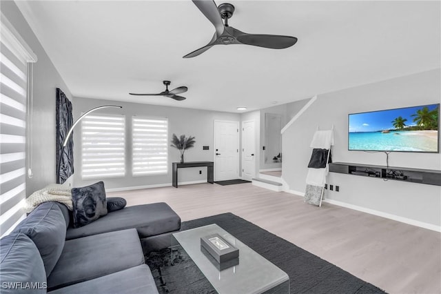 living room with ceiling fan and light wood-type flooring