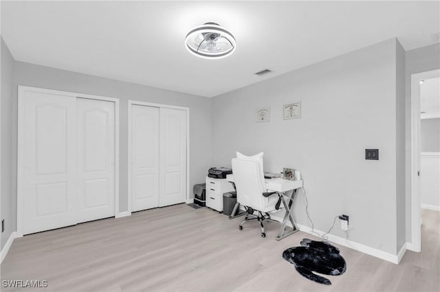 office space with light wood-type flooring