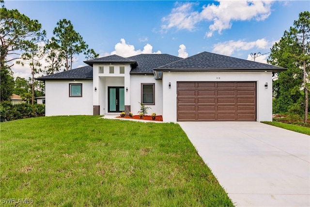 3005 28th St SW, Lehigh Acres, FL 33976 - prairie-style house featuring french doors, an attached garage, a front lawn, driveway, and stucco siding