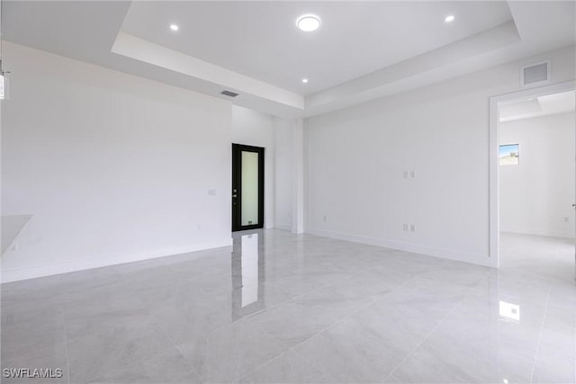 3005 28th St SW, Lehigh Acres, FL 33976 - empty room with a tray ceiling, recessed lighting, and baseboards