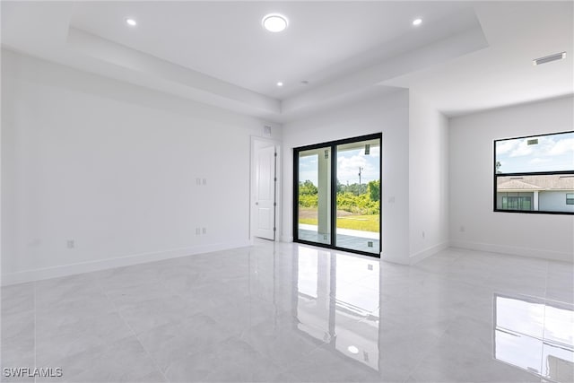 3005 28th St SW, Lehigh Acres, FL 33976 - empty room with a raised ceiling, baseboards, and recessed lighting
