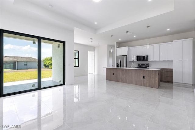 3005 28th St SW, Lehigh Acres, FL 33976 - kitchen with appliances with stainless steel finishes, modern cabinets, white cabinets, an island with sink, and a sink