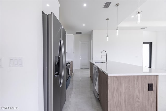 3005 28th St SW, Lehigh Acres, FL 33976 - kitchen with modern cabinets, appliances with stainless steel finishes, a sink, a spacious island, and recessed lighting