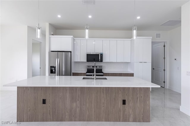 3005 28th St SW, Lehigh Acres, FL 33976 - kitchen with appliances with stainless steel finishes, modern cabinets, white cabinets, baseboards, and a large island with sink
