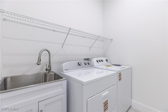 3005 28th St SW, Lehigh Acres, FL 33976 - washroom featuring washing machine and dryer, cabinet space, and baseboards