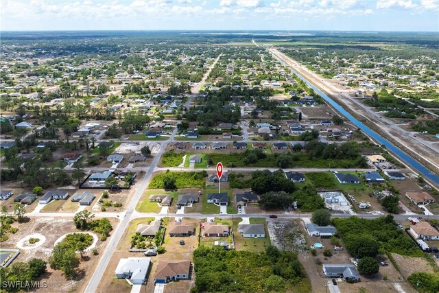 3005 28th St SW, Lehigh Acres, FL 33976 - aerial view of property and surrounding area with nearby suburban area