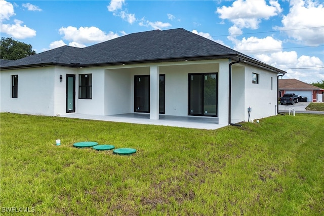 3005 28th St SW, Lehigh Acres, FL 33976 - back of house with a patio area, stucco siding, and a yard