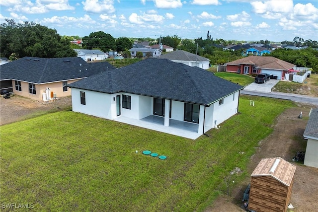 3005 28th St SW, Lehigh Acres, FL 33976 - rear view of house with a patio, a residential view, stucco siding, and a yard