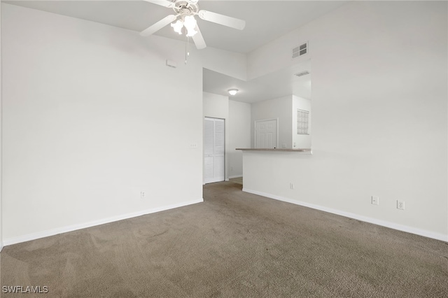 carpeted spare room featuring ceiling fan