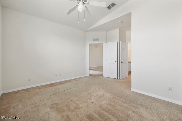 carpeted spare room featuring ceiling fan and lofted ceiling