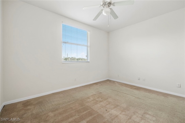 carpeted empty room featuring ceiling fan