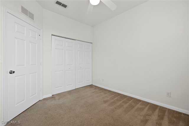 unfurnished bedroom featuring a closet, ceiling fan, and carpet