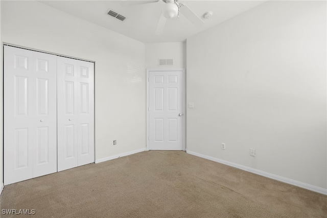 unfurnished bedroom with carpet, ceiling fan, and a closet