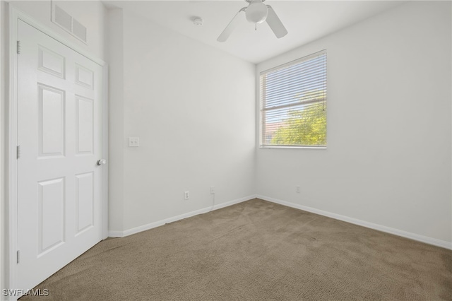 unfurnished room featuring ceiling fan and carpet flooring