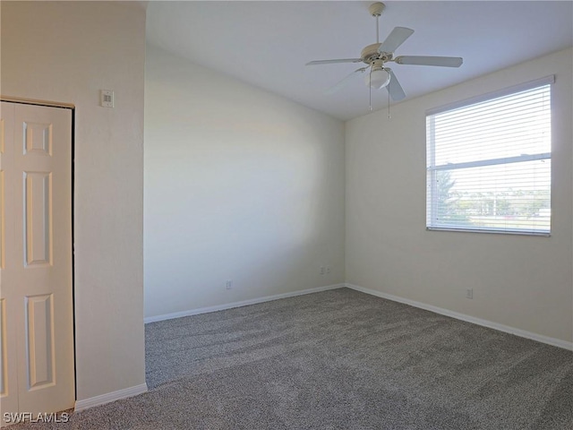 spare room featuring baseboards, carpet, and ceiling fan