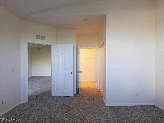 carpeted spare room featuring visible vents and baseboards