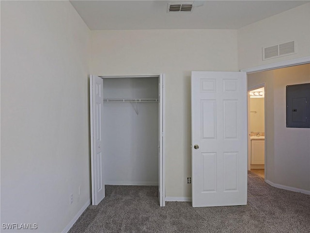 unfurnished bedroom with carpet floors, electric panel, and visible vents