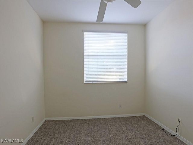 carpeted empty room with baseboards and ceiling fan