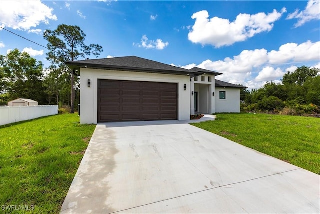 prairie-style house with concrete driveway, a garage, and stucco siding