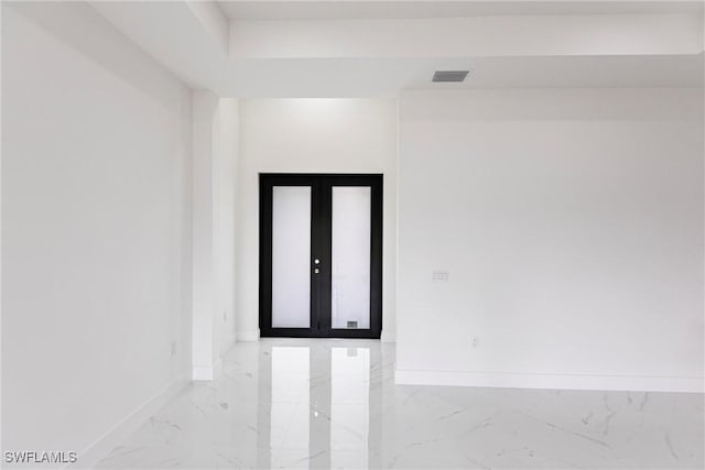 empty room with baseboards and marble tiled flooring