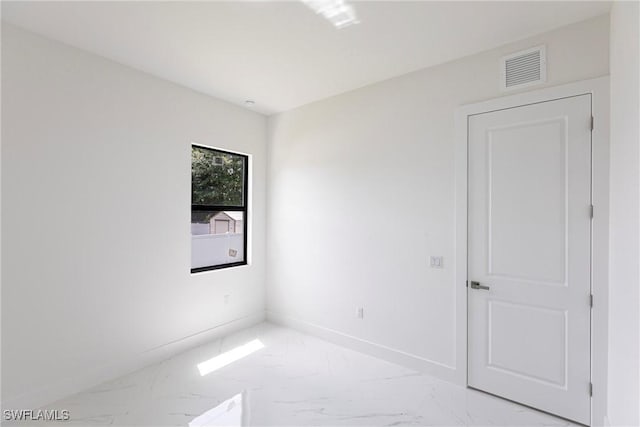 empty room with light marble finish floors and baseboards
