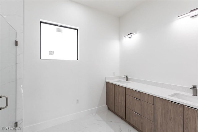 bathroom featuring a marble finish shower, marble finish flooring, double vanity, and baseboards