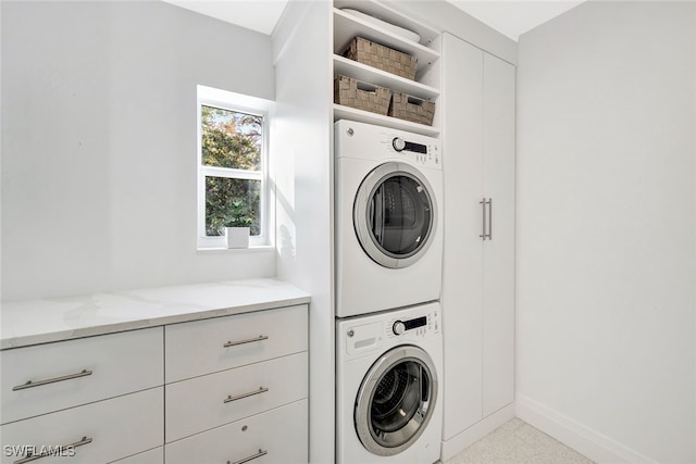 laundry area featuring stacked washer and clothes dryer