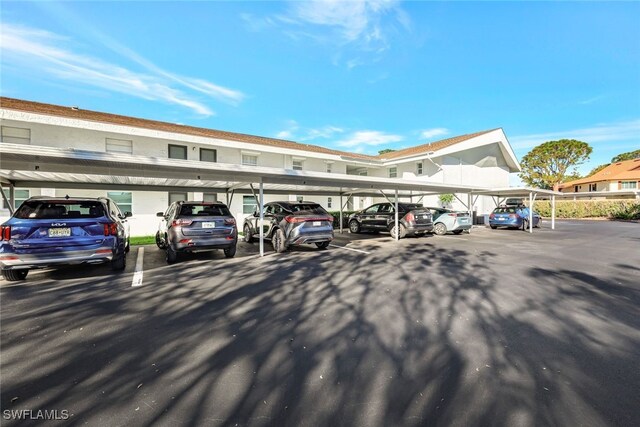 view of parking / parking lot featuring a carport