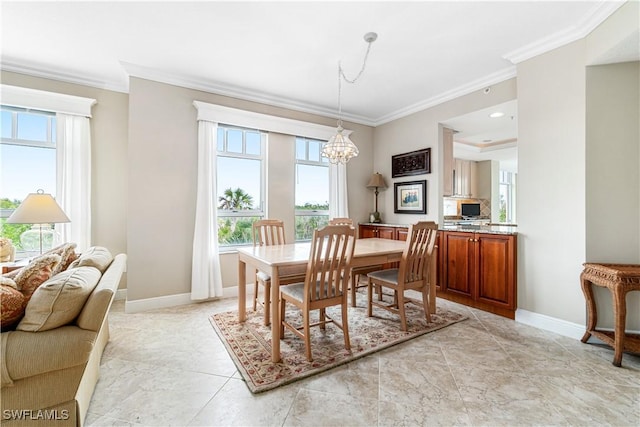 dining area with crown molding, plenty of natural light, and a chandelier