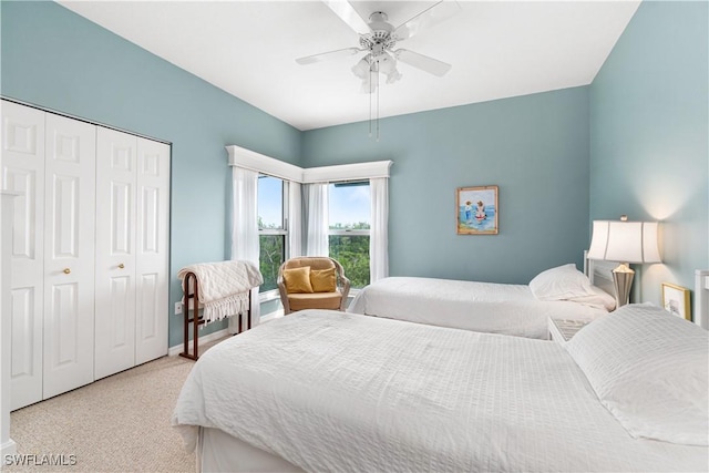 carpeted bedroom with ceiling fan and a closet