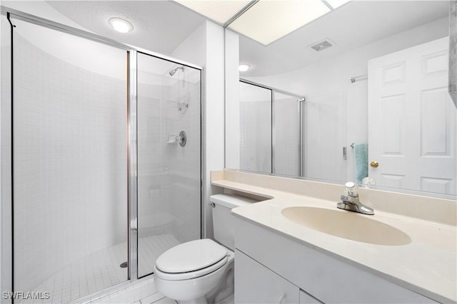 bathroom with an enclosed shower, vanity, and toilet