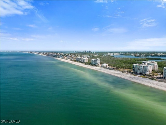 birds eye view of property featuring a water view and a beach view