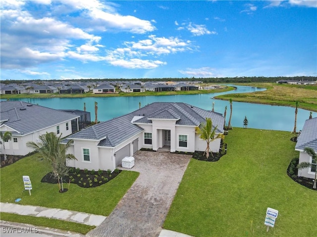 birds eye view of property with a water view