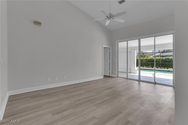 unfurnished room featuring visible vents, baseboards, a ceiling fan, light wood-type flooring, and high vaulted ceiling