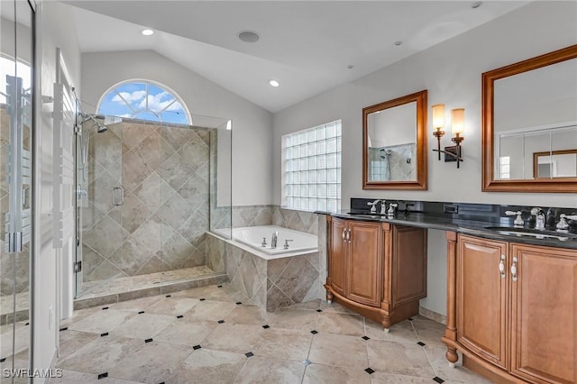 bathroom featuring lofted ceiling, a garden tub, a sink, and a shower stall