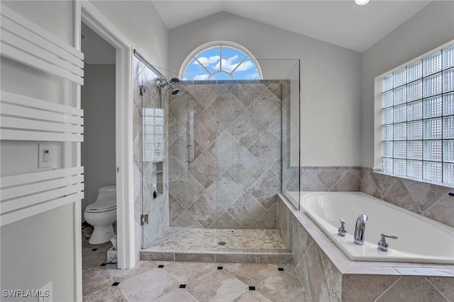 bathroom with toilet, a stall shower, a garden tub, and lofted ceiling