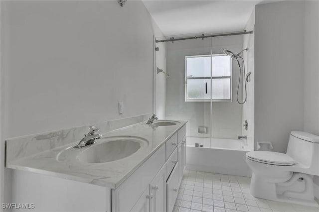 full bathroom with toilet, tile patterned flooring, double vanity, and a sink