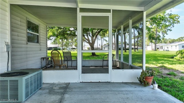 exterior space featuring central AC unit and a sunroom