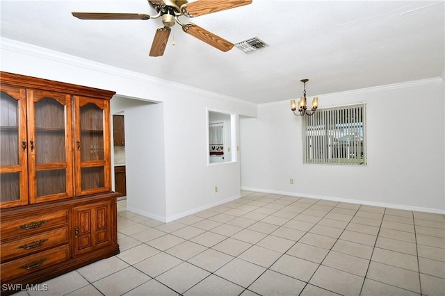 empty room featuring ceiling fan with notable chandelier, crown molding, and light tile patterned floors