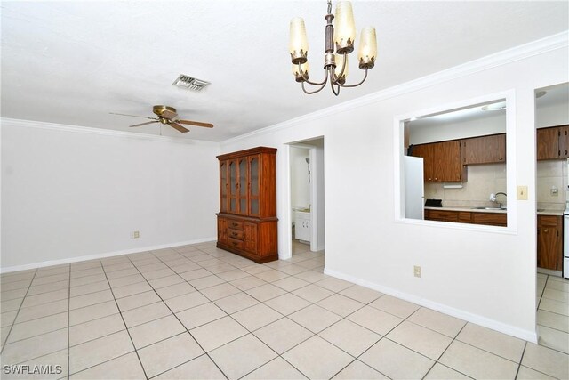 unfurnished room featuring sink, ceiling fan with notable chandelier, crown molding, and light tile patterned floors