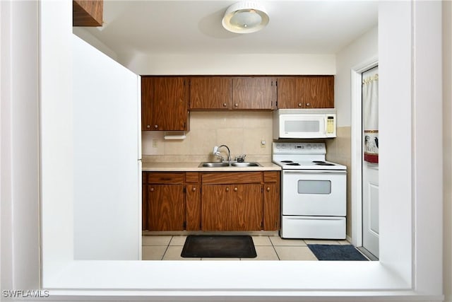 kitchen featuring sink, white appliances, tasteful backsplash, and light tile patterned flooring