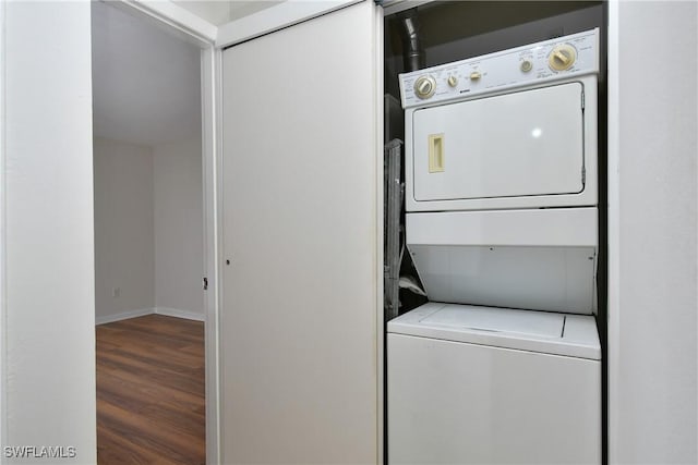 clothes washing area featuring wood-type flooring and stacked washer and dryer