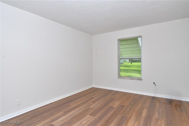 unfurnished room featuring dark hardwood / wood-style flooring